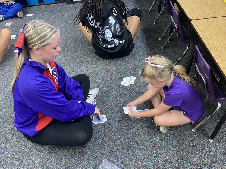 Eighth graders partnered with kindergarten today to learn a fun new card game that helps practice comparing bigger and smaller numbers.