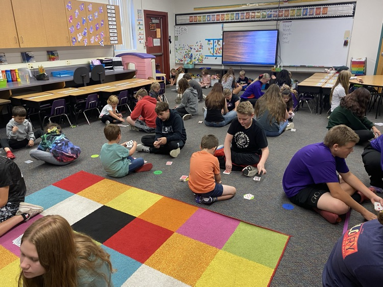 Eighth graders partnered with kindergarten today to learn a fun new card game that helps practice comparing bigger and smaller numbers.