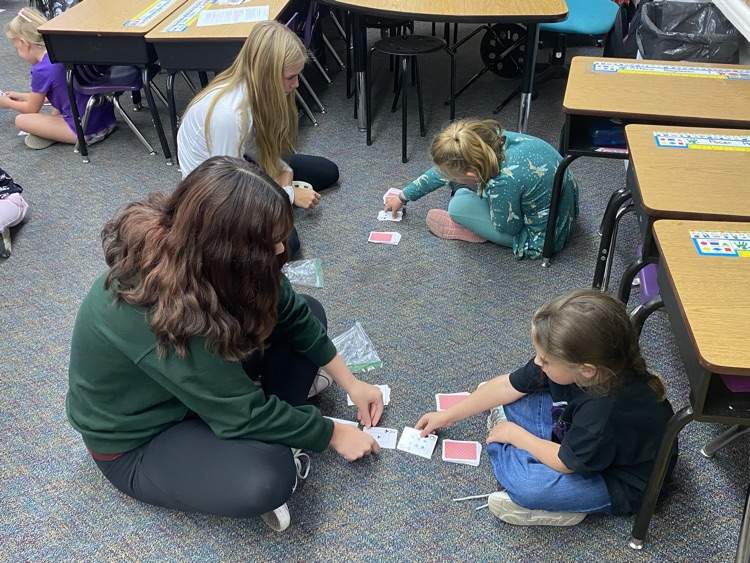 Eighth graders partnered with kindergarten today to learn a fun new card game that helps practice comparing bigger and smaller numbers.