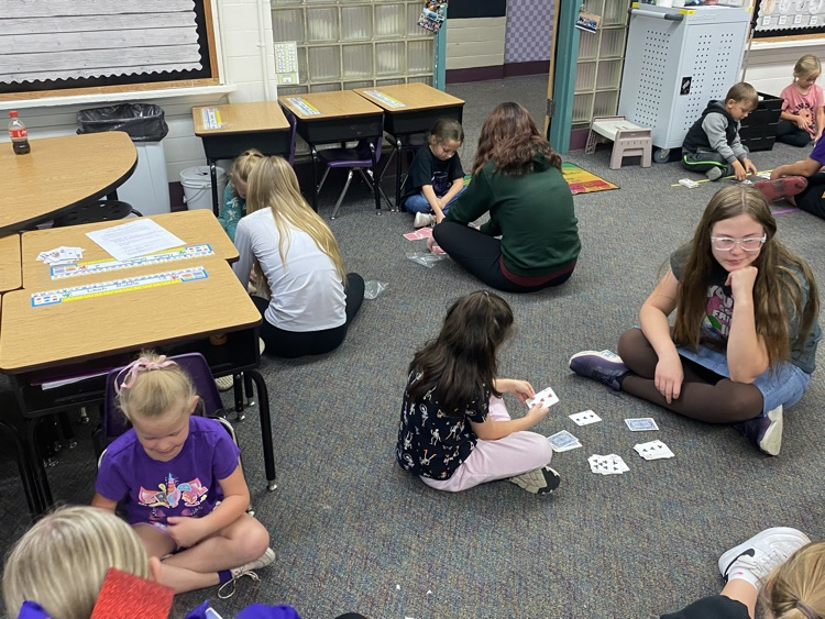Eighth graders partnered with kindergarten today to learn a fun new card game that helps practice comparing bigger and smaller numbers.
