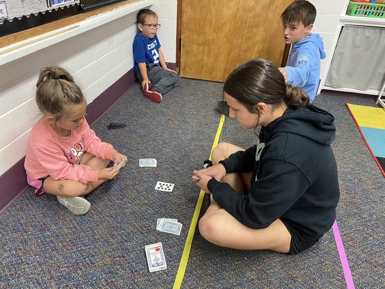 Eighth graders partnered with kindergarten today to learn a fun new card game that helps practice comparing bigger and smaller numbers.