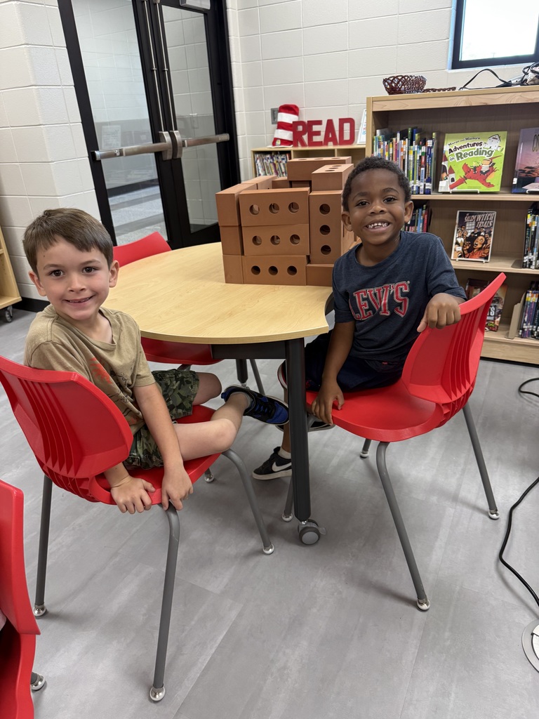 Miss Jodi Harper and Miss Jalee’ Conley’s class had an enrichment activity in the library. Mrs. Godwin read, “No Lie, Pigs (And Their Houses) Can Fly!” and a non fiction book about pigs. Students had to identify the characters and the setting of the story and the difference between fiction and non fiction texts. After the story, students had to create their own houses (setting) around a pig (character) taped to the tables. Items to build the houses included magnatiles, magnetic blocks, cups, dominoes, lincoln logs, fake bricks, and fake cement blocks. The idea was to make it strong enough not to get blown down. Miss Jodi used a hair dryer as the Big Bad Wolf. The class had lots of fun with this activity. 