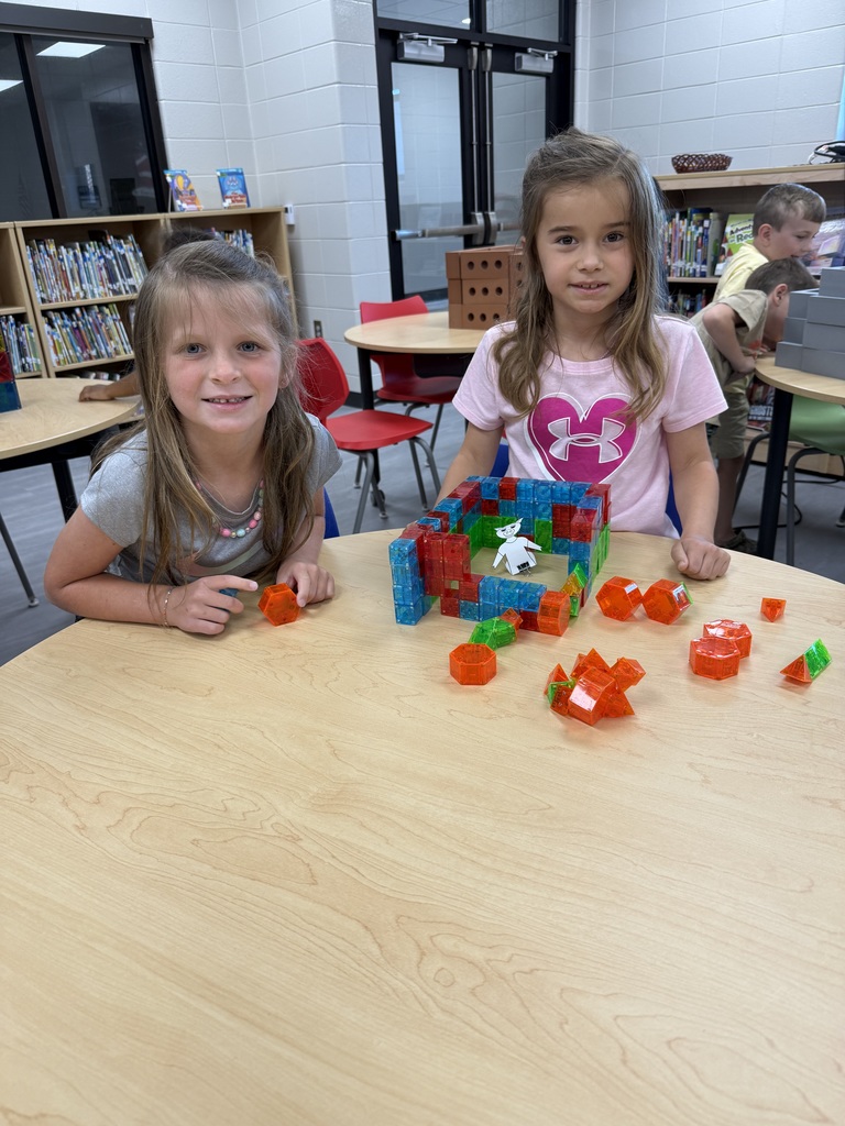 Miss Jodi Harper and Miss Jalee’ Conley’s class had an enrichment activity in the library. Mrs. Godwin read, “No Lie, Pigs (And Their Houses) Can Fly!” and a non fiction book about pigs. Students had to identify the characters and the setting of the story and the difference between fiction and non fiction texts. After the story, students had to create their own houses (setting) around a pig (character) taped to the tables. Items to build the houses included magnatiles, magnetic blocks, cups, dominoes, lincoln logs, fake bricks, and fake cement blocks. The idea was to make it strong enough not to get blown down. Miss Jodi used a hair dryer as the Big Bad Wolf. The class had lots of fun with this activity. 