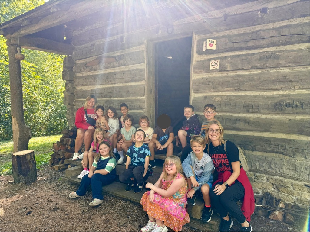 class in front of cabin