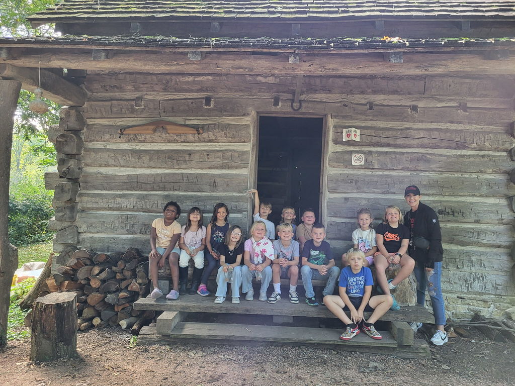 class in front of cabin