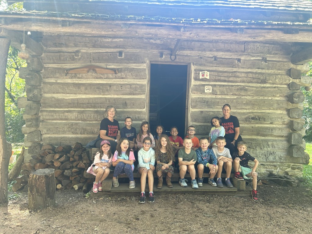 class in front of cabin