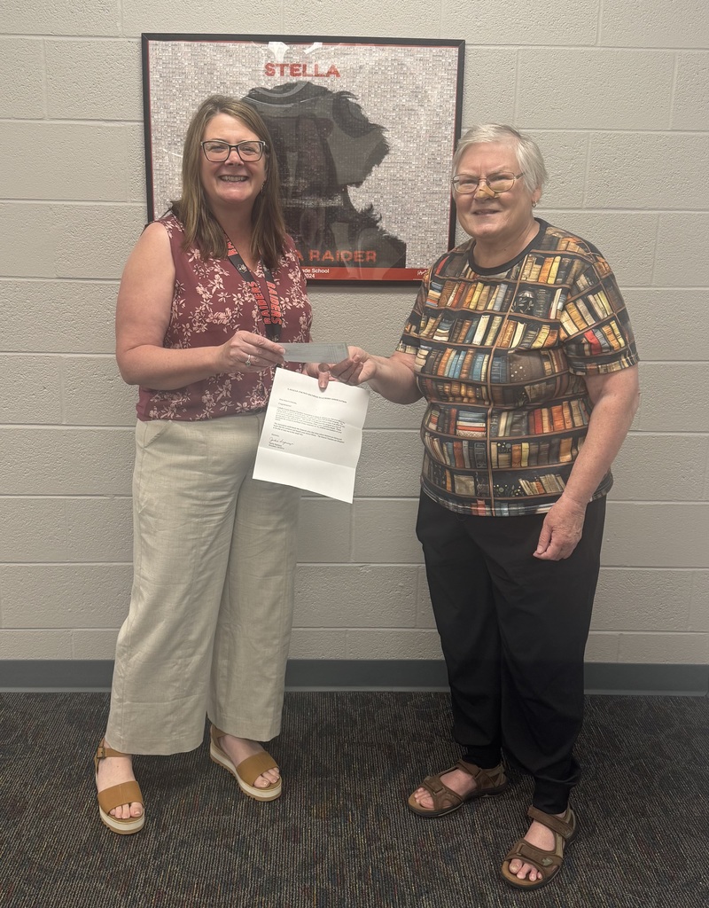Mrs. McGhee accepting the check from Ms. Freepartner