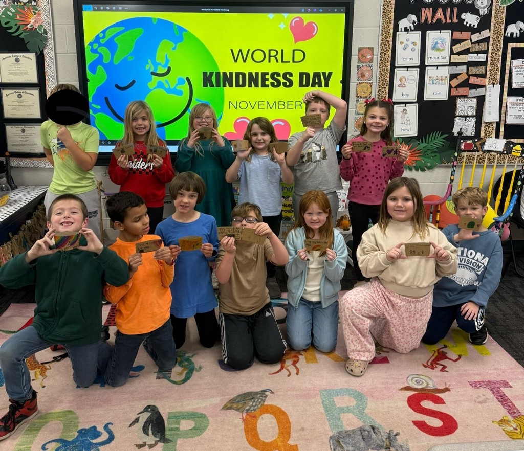 Students holding up coffee sleeve