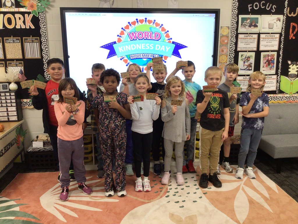 Students holding up coffee sleeve