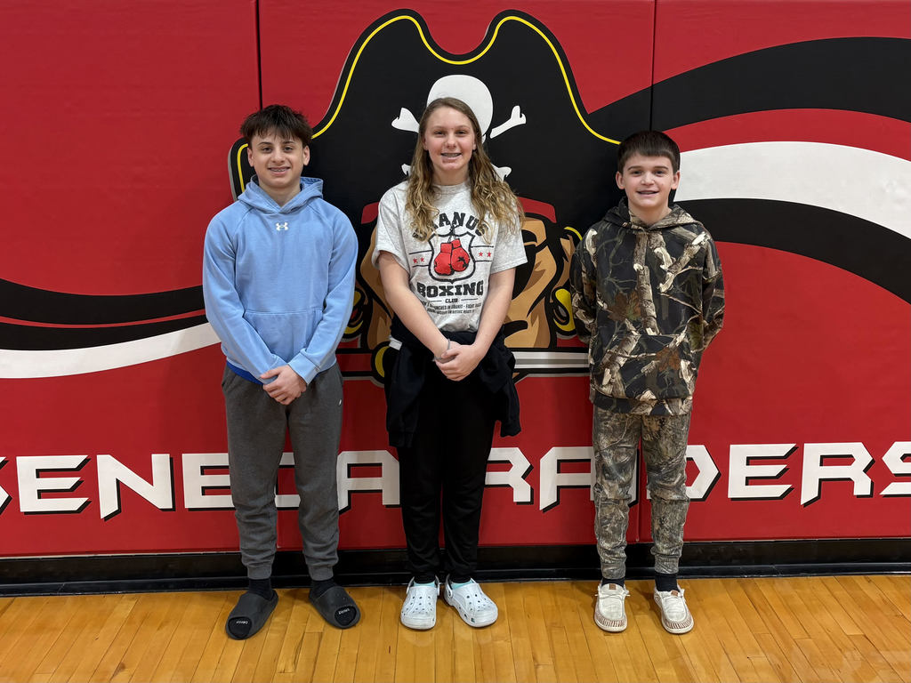 3 middle school students pose for a picture after the spelling bee.  
