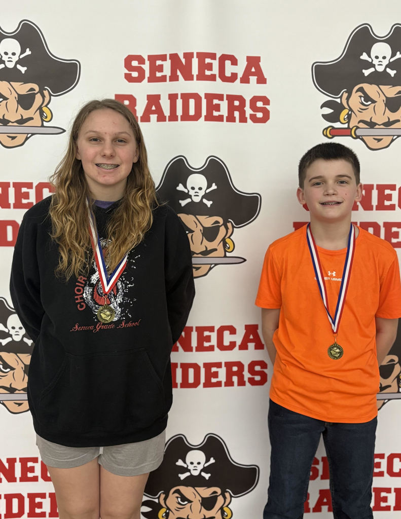 Middle school students pose with medals they earned at a spelling bee.  