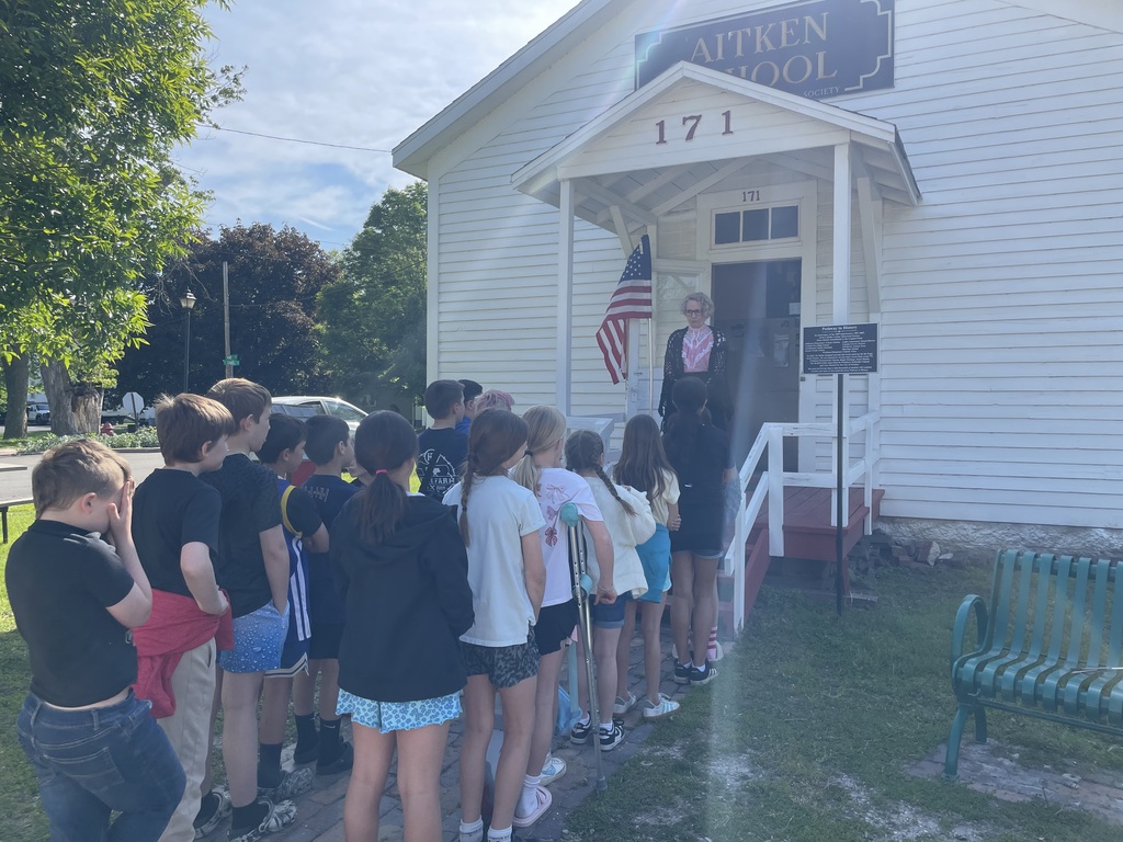 Students outside schoolhouse