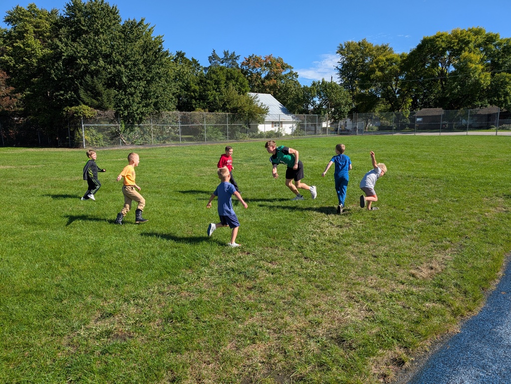 Students playing in grass