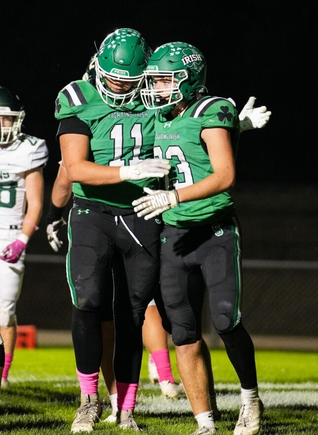 Seniors Cam Shriey and Zeb Maxwell put on their Irish helmets one last time in the Illinois High School Shrine Football Game on Saturday. 