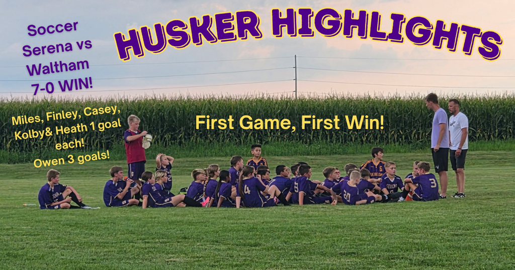 Soccer Team and coaches on field at sunset near cornfield 