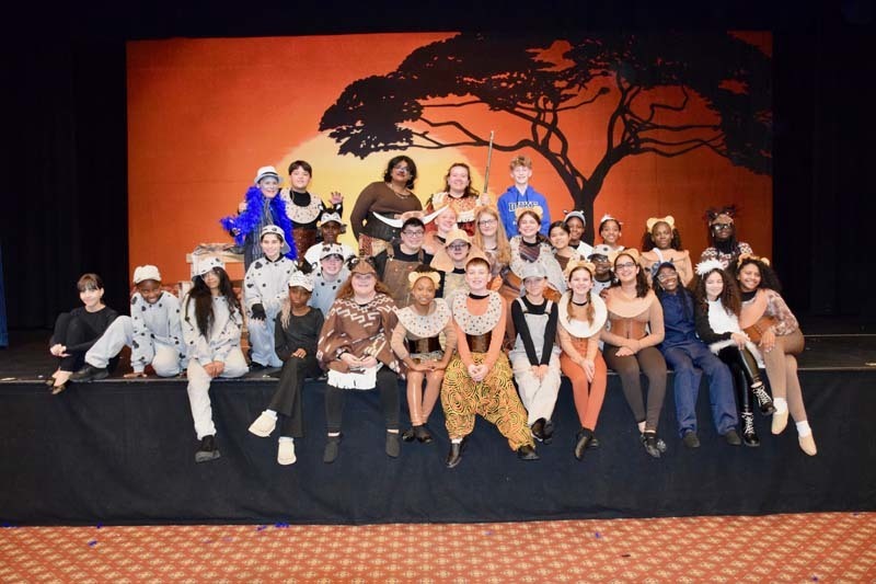 Students on stage performing lion king