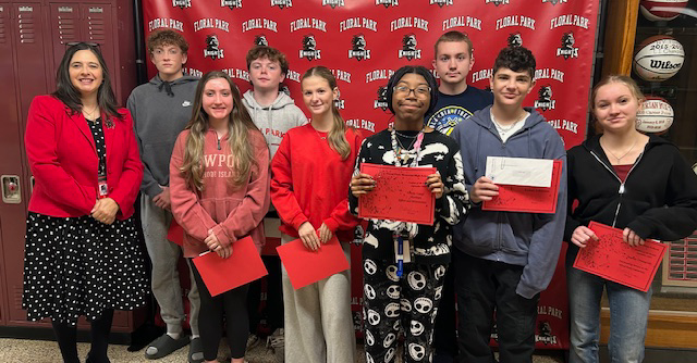 students in hall with red papers