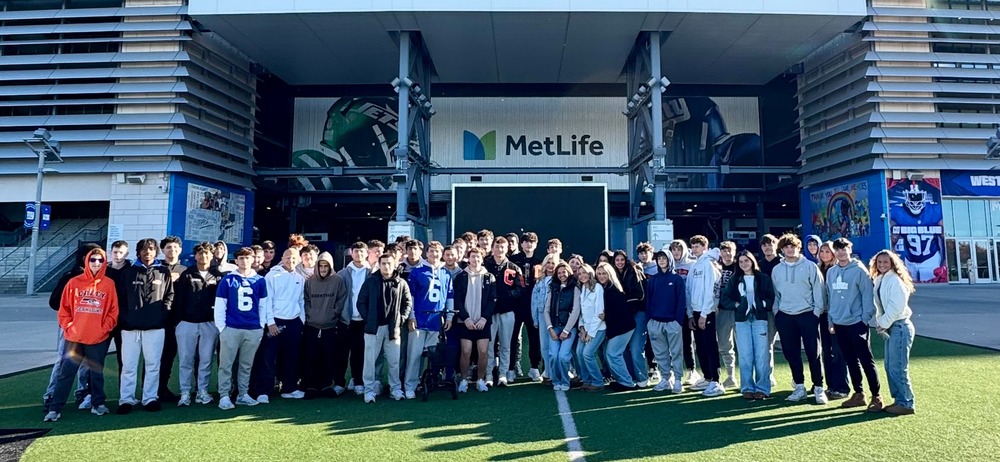 students in front of stadium