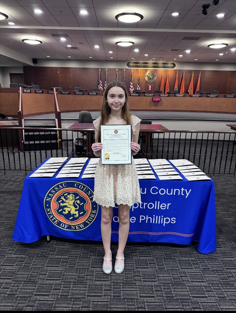 Student holding award.