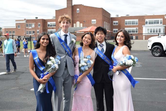 Students dressed formally in parking lot for homecoming.