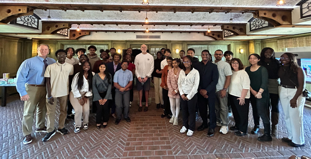 Business students with AriZona employees.
