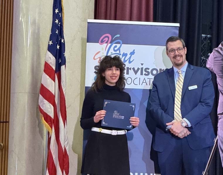 Student receiving award from teacher.