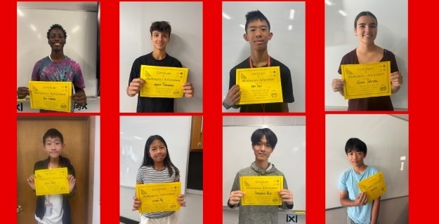 Students holding up their perfect score certificates.