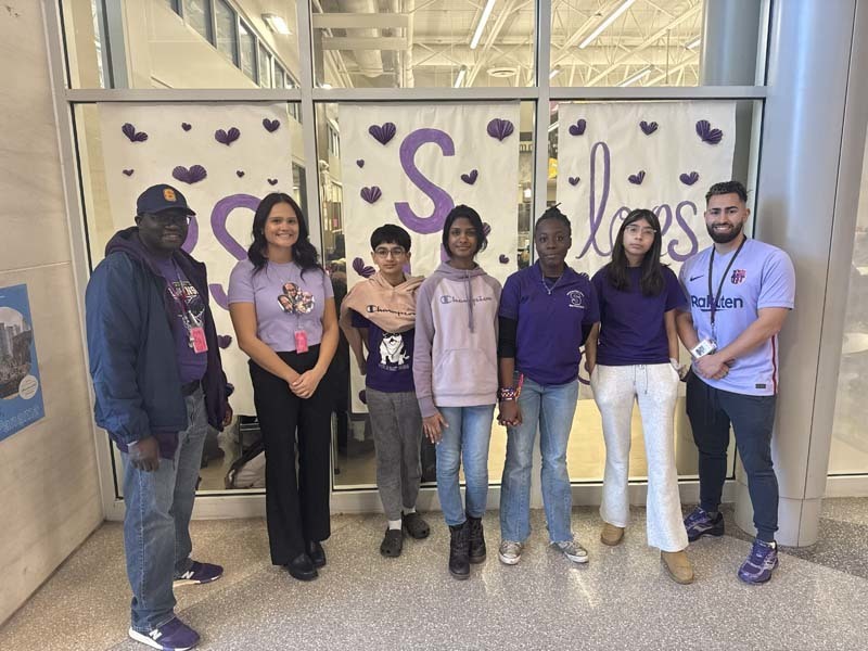 Students and staff dressed in purple to commemorate P.S. I Love You Day on Feb. 13, writing messages of kindness on hearts near the cafeteria. 
