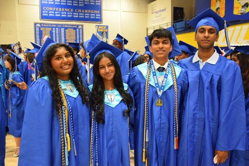 Graduating seniors smiling together.