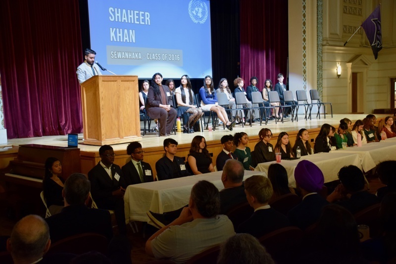 Graduation ceremony at Sewanhaka High School featuring speaker Shaheer Khan, with students on stage and an audience in attendance, showcasing the celebration of the Class of 2016.