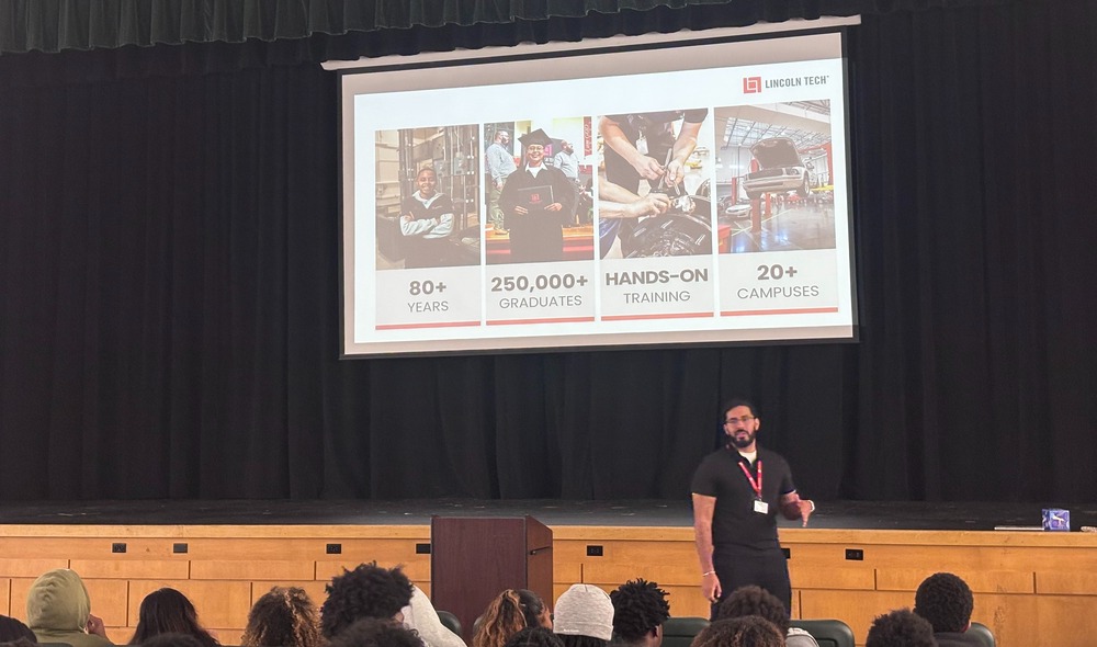 A person presents information about Lincoln Tech to an audience in a classroom setting.