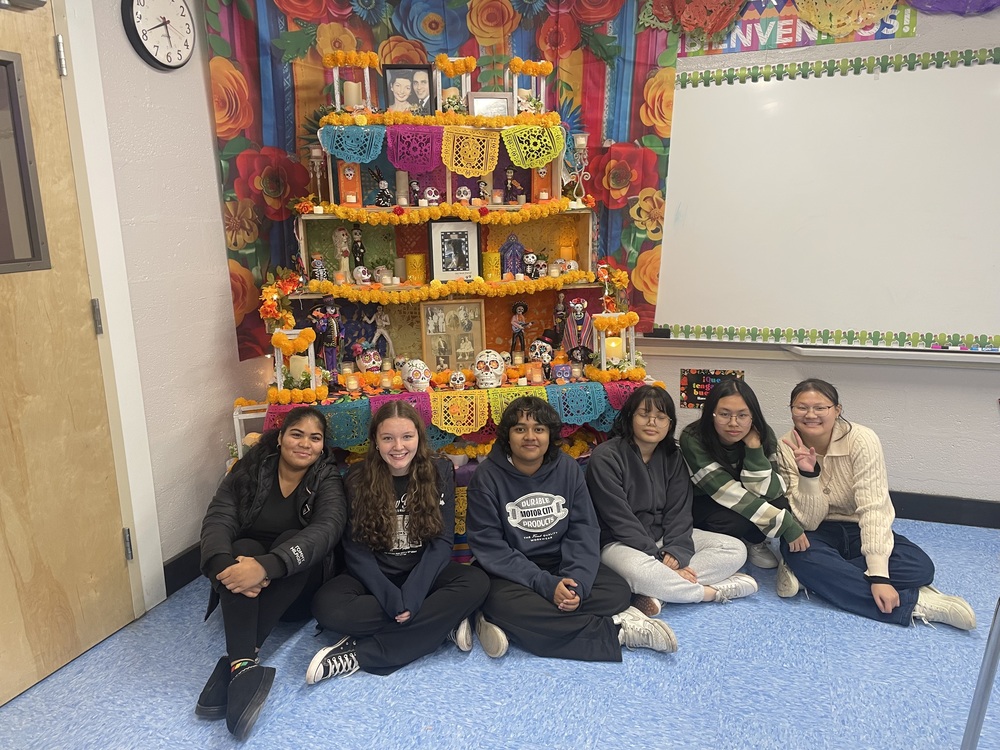 Students standing in front of memorial.