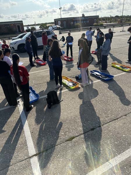 Students in parking lot of school.