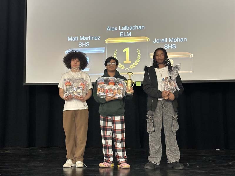 Students holding their prizes.