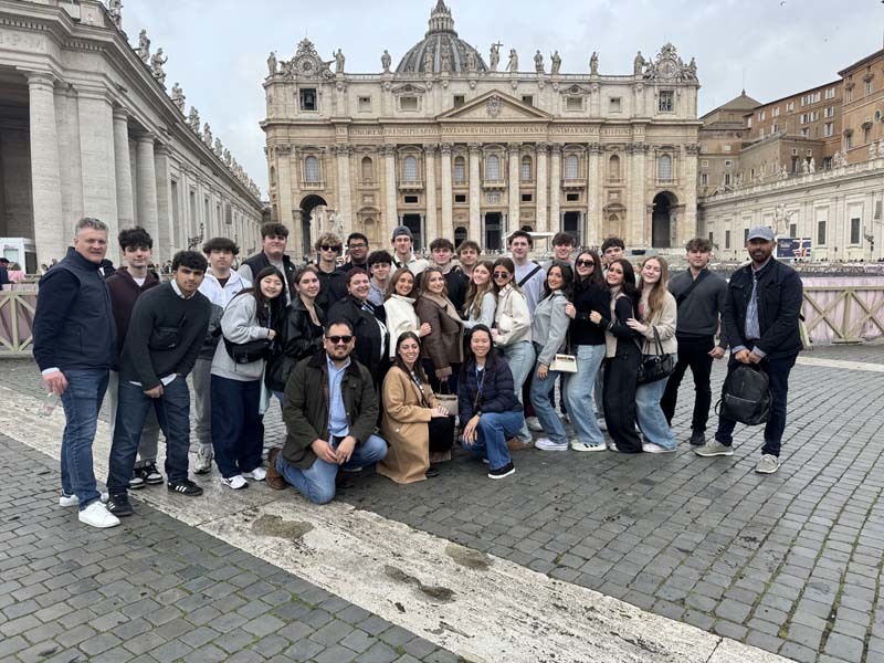 Students standing in front of historic building.