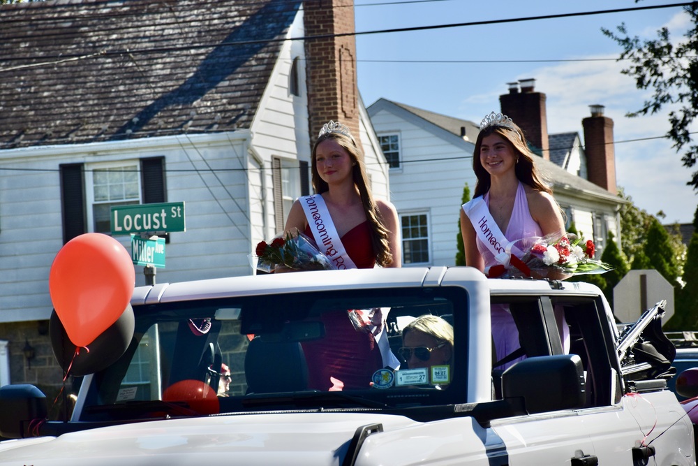 Students riding on homecoming float.