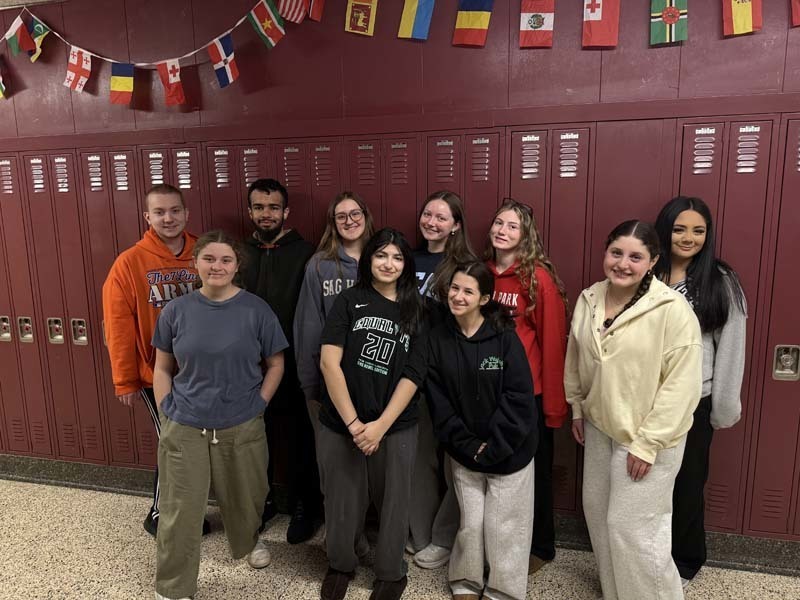 Students standing in front of lockers. 