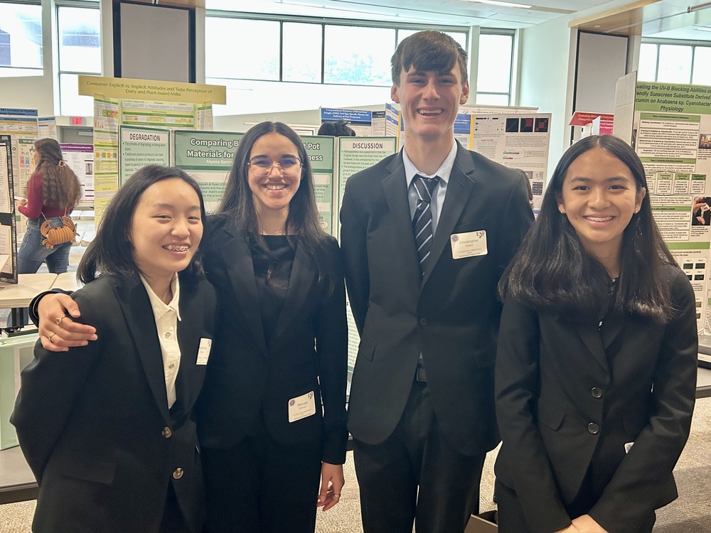 Students dressed formally, smiling together.
