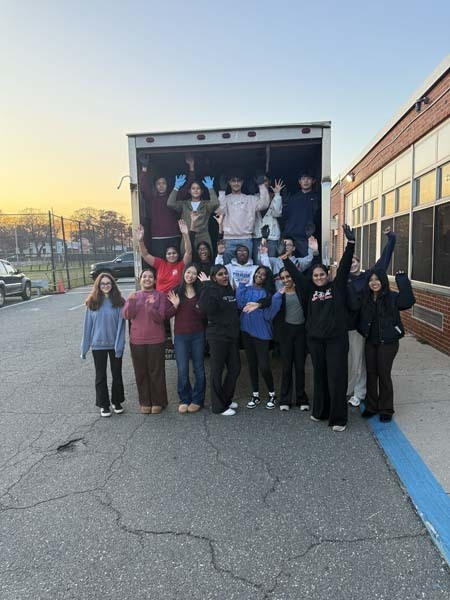 Students standing in and around truck.