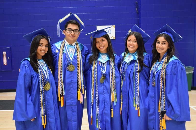 Graduating seniors smiling together.