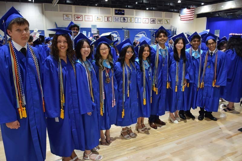 Graduating seniors smiling together.