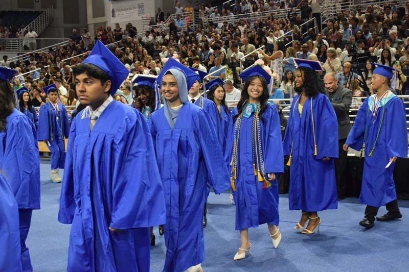 Graduating seniors smiling together.