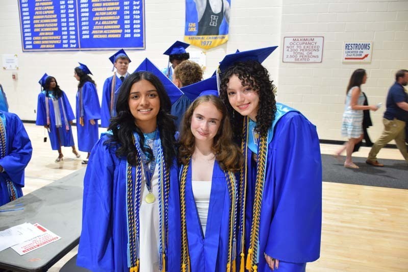 Graduating seniors smiling together.