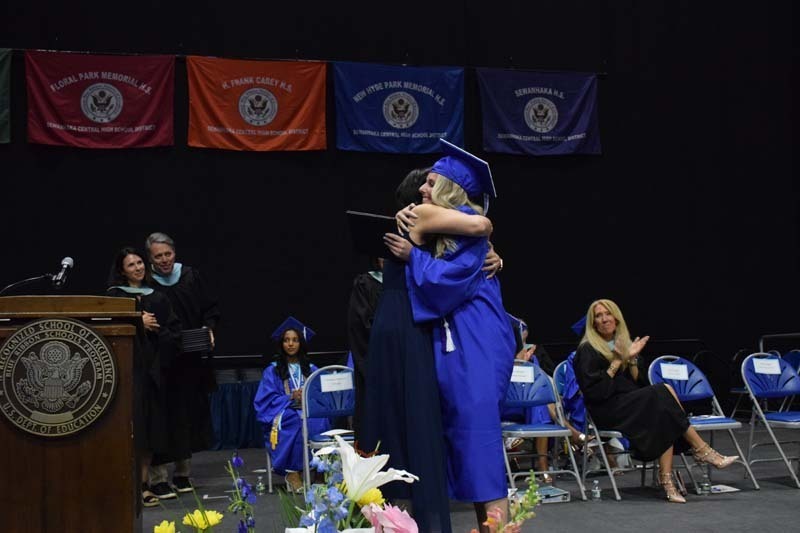 Graduating seniors smiling together.