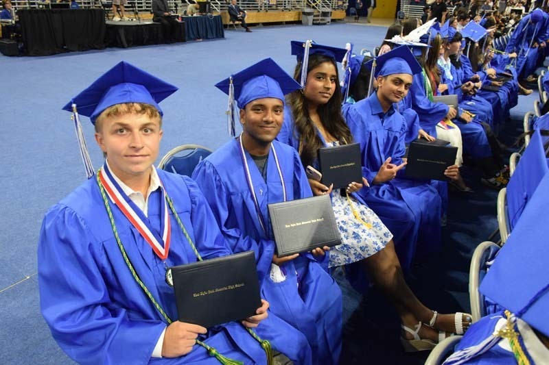 Graduating seniors smiling together.
