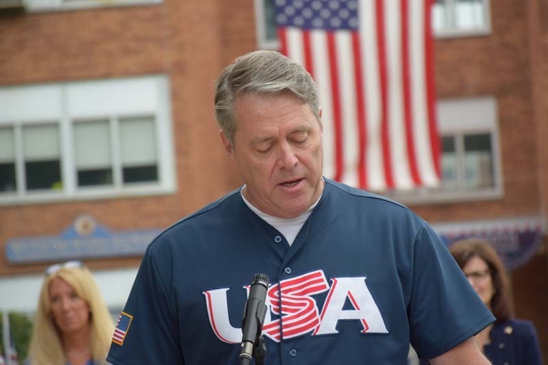 Man giving speech at microphone.