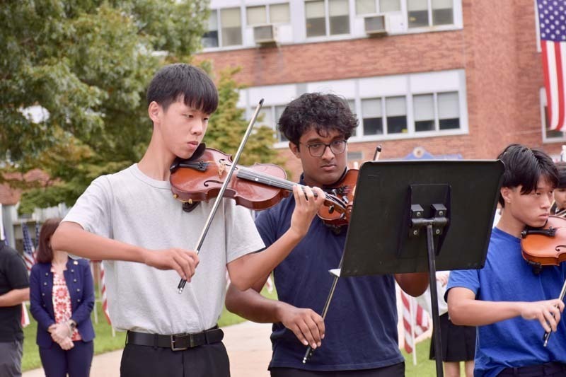 Students playing violins.