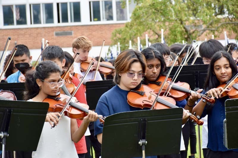 Group of students playing violins.