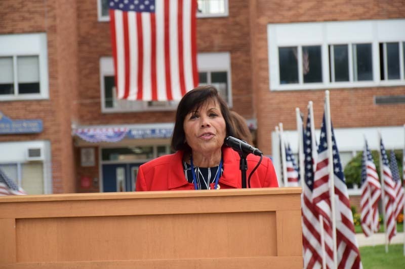 Woman giving speech at podium.