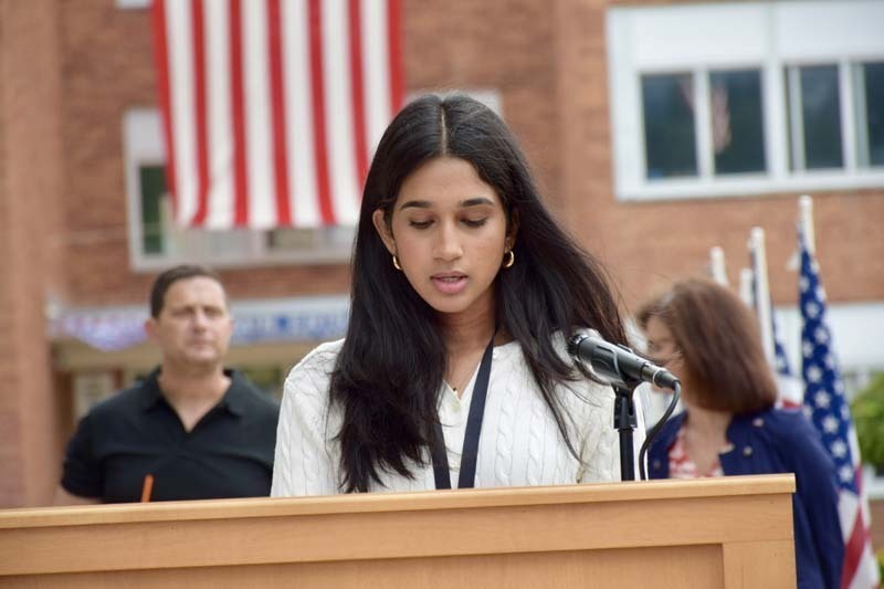 Woman giving speech at podium.